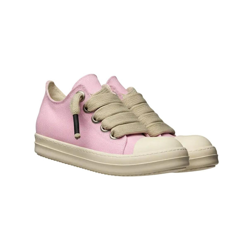 Pink sneakers with beige laces on a decorative column against a gray background