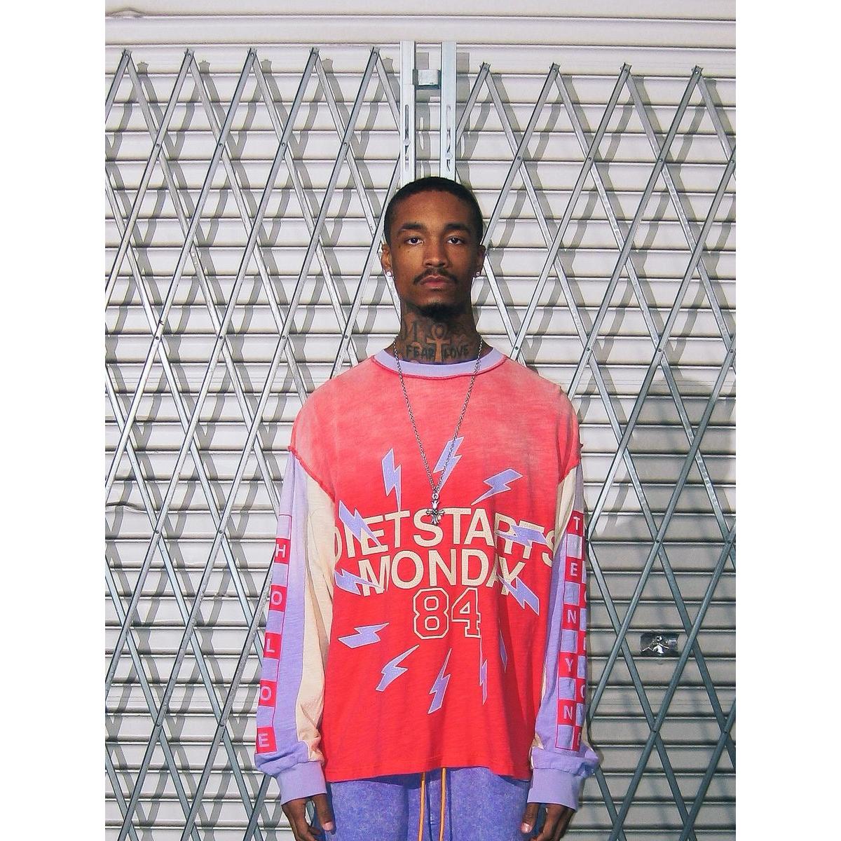 Red and purple vintage-wash long sleeve with Diet Starts Monday graphic, lightning bolts, and contrast panel sleeves.