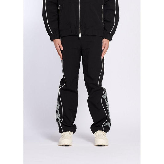Black Y2K track pants with white piping, side graphic details, and a relaxed athletic fit.