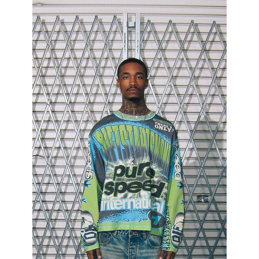 Blue, green, and black long-sleeve motocross jersey with Pure Speed International graphics and bold racing typography.
