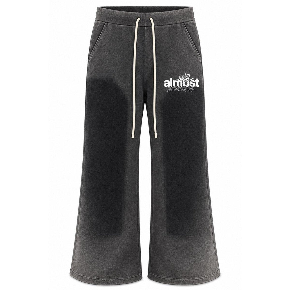 Almost Someday black washed flared sweatpants with a vintage finish, white graphic logo, and drawstring waistband.