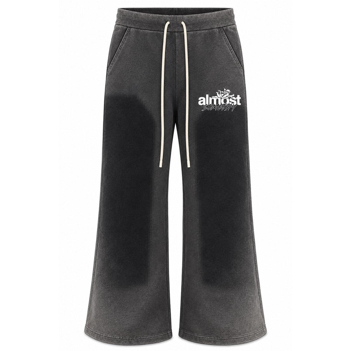 Almost Someday black washed flared sweatpants with a vintage finish, white graphic logo, and drawstring waistband.