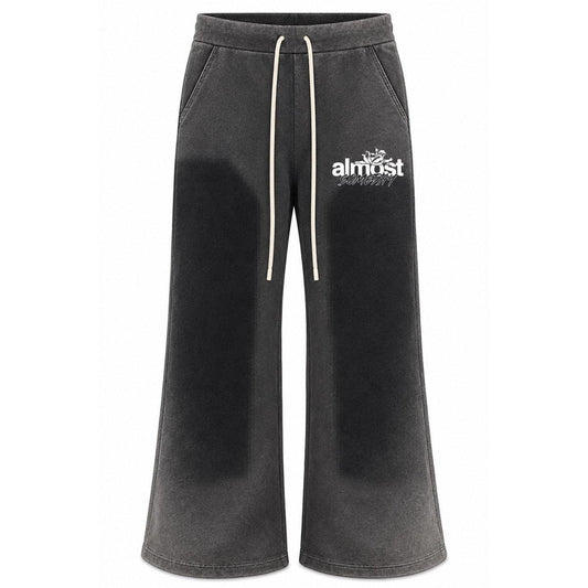 Almost Someday black washed flared sweatpants with a vintage finish, white graphic logo, and drawstring waistband.
