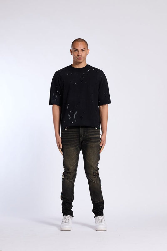 Model showcasing Crysp Denim | Floral Rhinestone Skinny Jeans with a black t-shirt and white sneakers.
