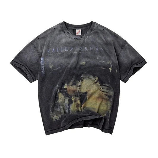Washed charcoal vintage tee with distressed embrace photo graphic and faded typography.