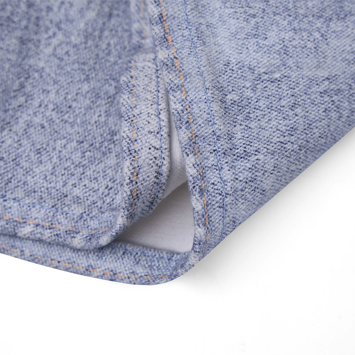 Close-up of blue denim fabric with visible stitching on a white background