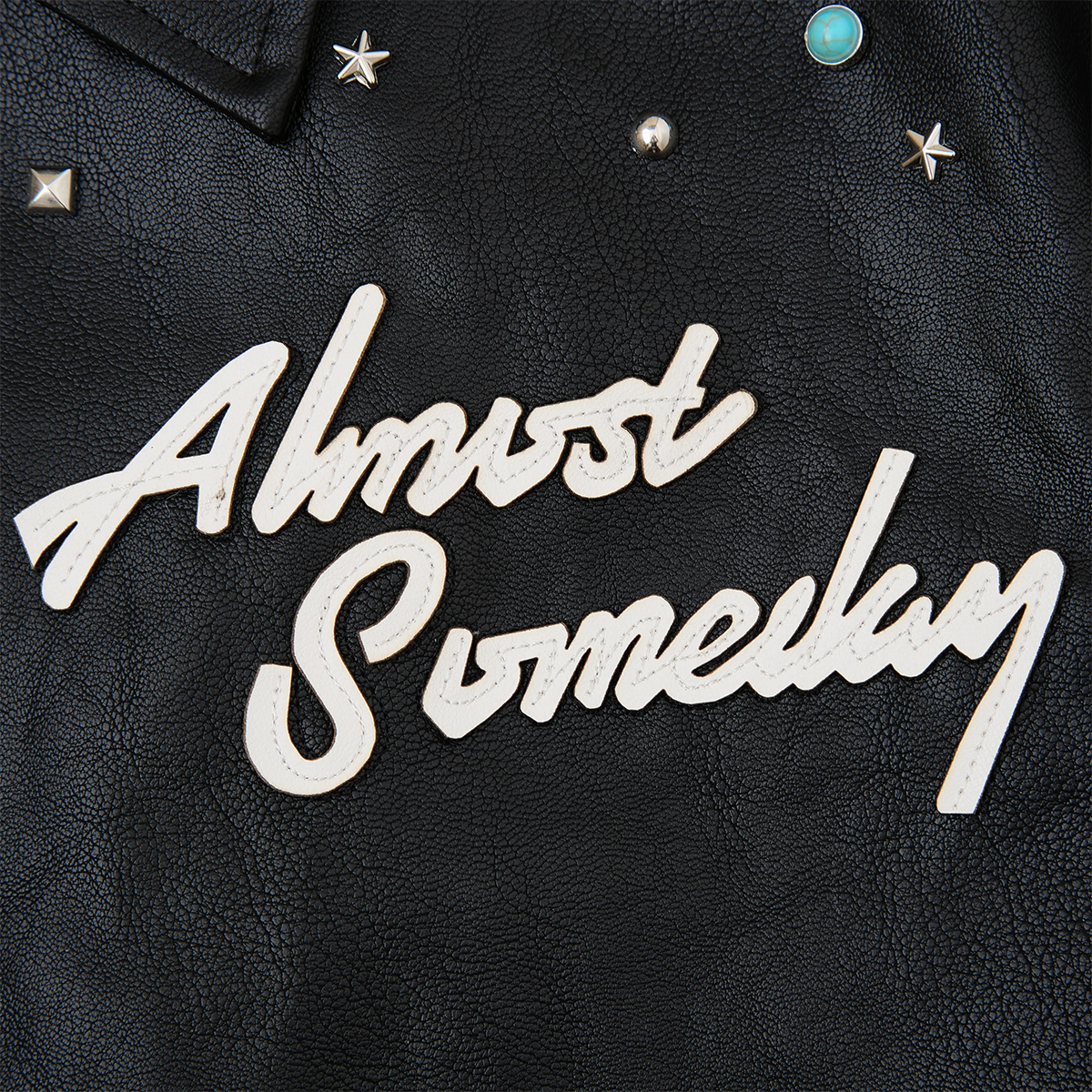 Black leather jacket with 'Almost Someday' text in white on a dark background