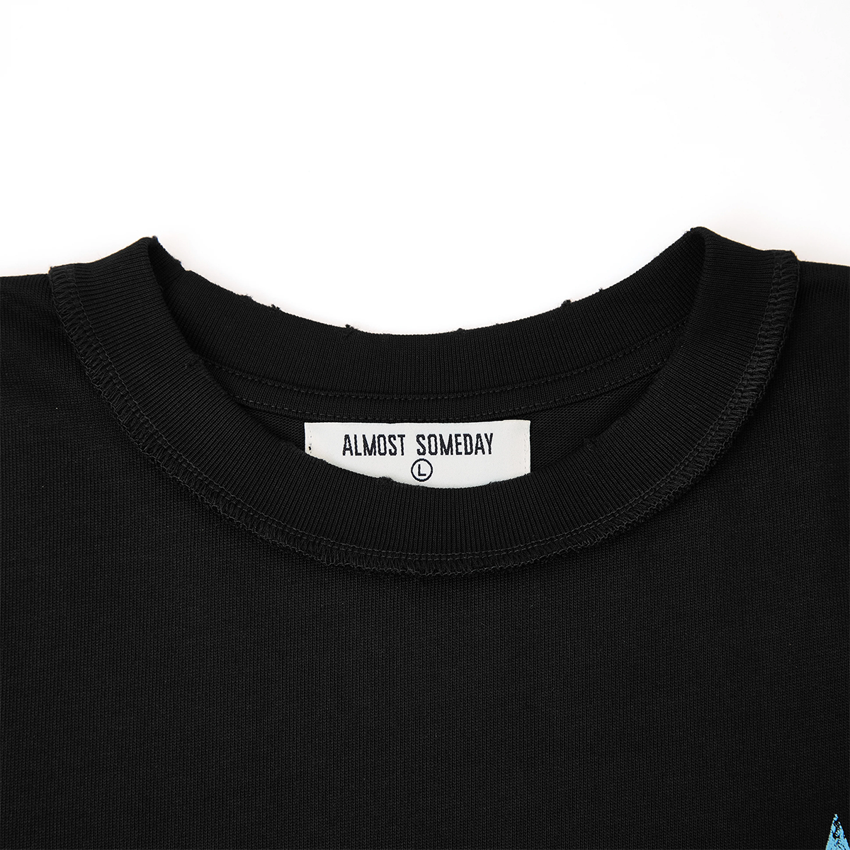 Black t-shirt with 'Almost Someday' label on a white background