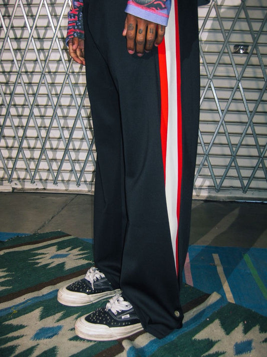Diet Starts Monday | Striped Sweatpants - Black worn, showcasing bold red and white racing stripes on black fabric.