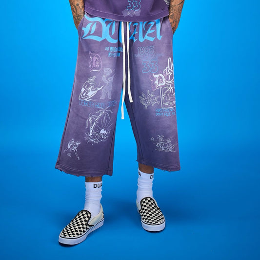Purple Duaa streetwear capri shorts with a relaxed fit, raw hem, and white graphic prints on a blue background.