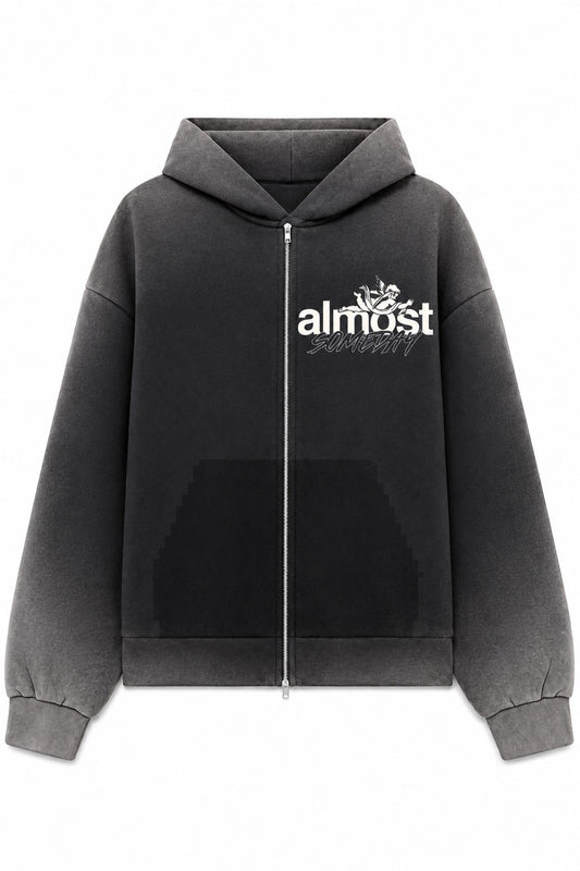 Black washed zip-up hoodie with white Almost Someday logo, front zipper, and vintage-inspired streetwear aesthetic.