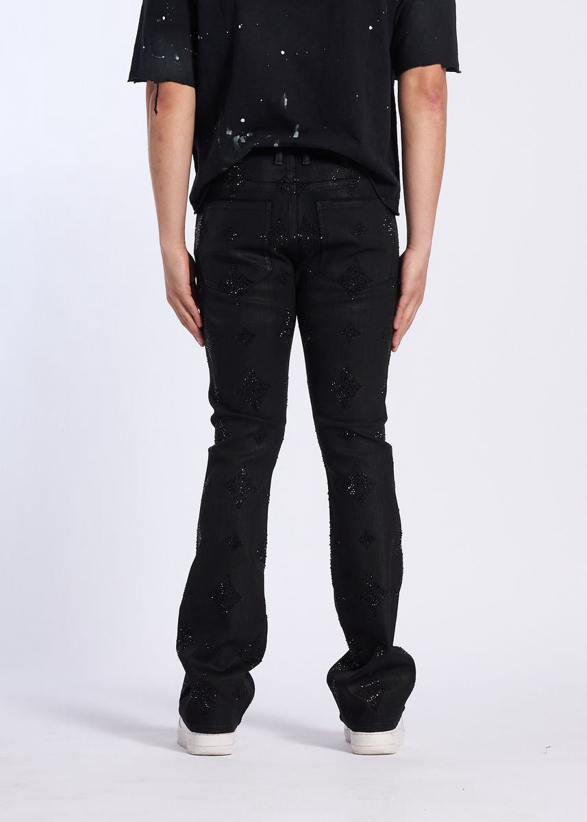 Back view of person wearing Crysp Denim | Onyx Rhinestone Stacked Pants - Black Wax with casual black shirt.