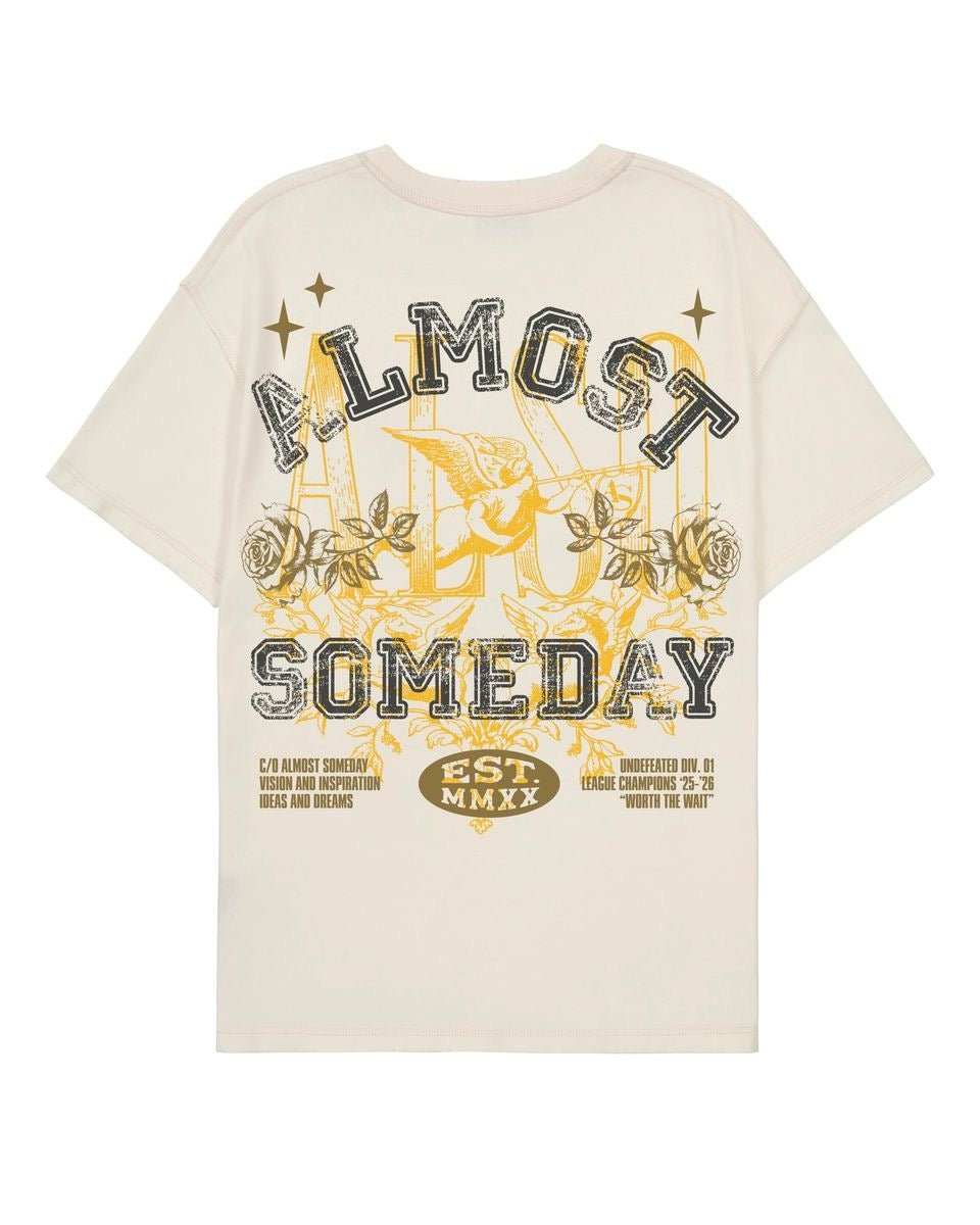 Cream short-sleeve crewneck tee featuring a vintage-style Almost Someday graphic with an angel, roses, and gold lettering.
