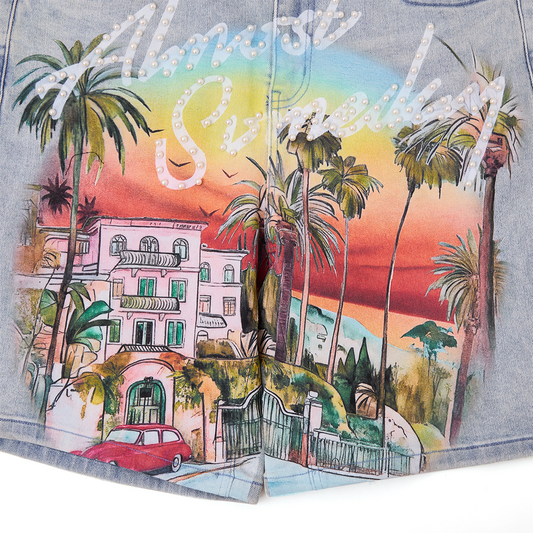 close up on blue denim shorts with immersive hollywood print and pearl script branding