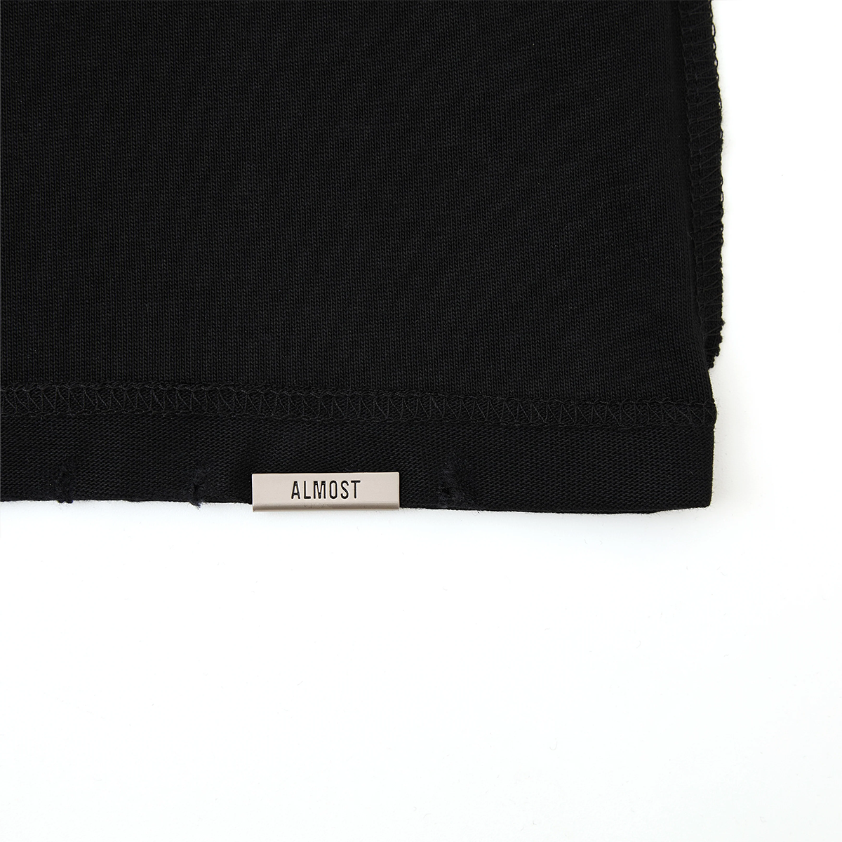 Black fabric with 'ALMOST' label on a white background